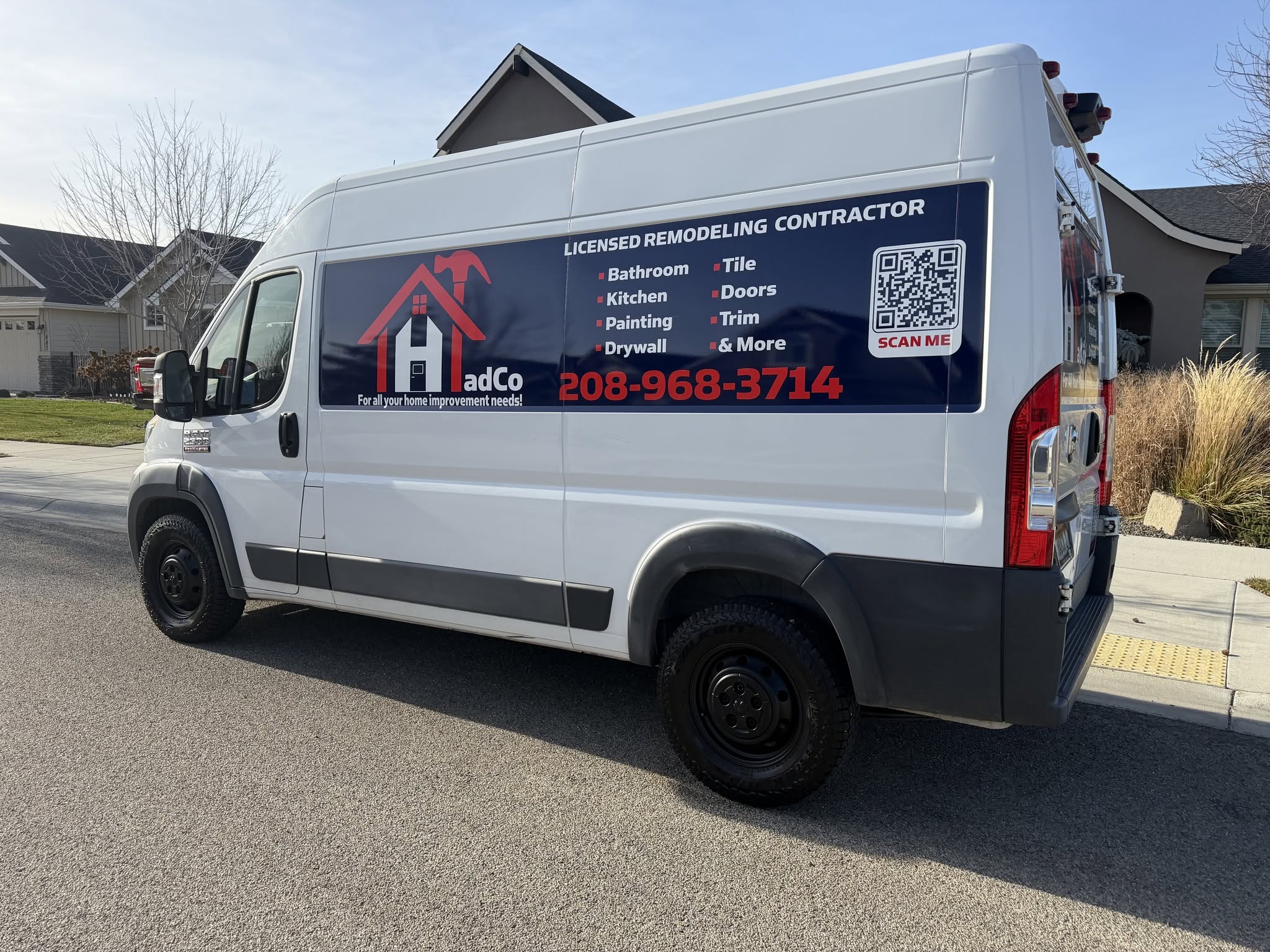 HadCo’s white work van displaying the house-and-hammer logo, remodeling services and phone number